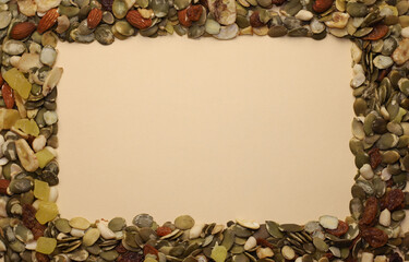 There is a mixture of nuts and dried fruits around the edges, and there is empty space for text in...