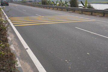 A speed bump also known as a road hump or sleeping policeman which is a traffic calming device used...