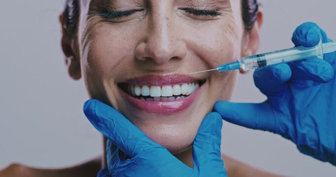 Injection, mouth and happy woman in studio for plastic surgery, lip filler and antiaging treatment. Surgeon hands, syringe or person on white background for cosmetology, collagen implant and skincare