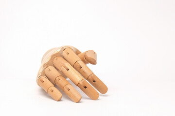 Close up Wooden hand model with prone palm pose isolated on white background.Copy space for text.For graphic design,3D rendering or banner background