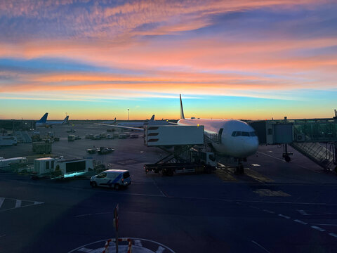 Airplane execute push back operation at airport. Aircraft service for flights before departure in the evening at sunset