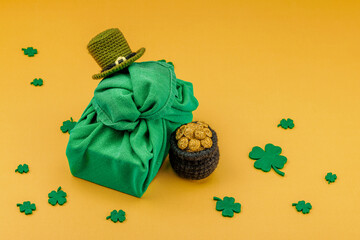 Handmade St. Patrick's Day gift concept. Furoshiki, decorative symbols, crocheted leprechaun hat