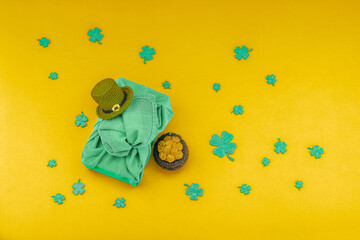 Handmade St. Patrick's Day gift concept. Furoshiki, decorative symbols, crocheted leprechaun hat