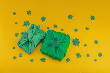 Handmade St. Patrick's Day gift concept. Furoshiki, decorative symbols, crocheted leprechaun hat