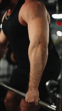 Muscular powerlifter executing heavy barbell rows, displaying raw strength while training intensely at professional strength gym
