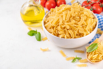 Raw Mafaldine pasta with ingredient for cooking
