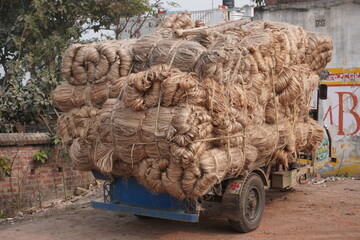 large quantity of jute fiber, likely in the form of raw bales or bundles, being transported on a...