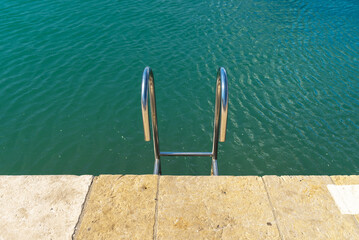 Metal ladder leading into the water.