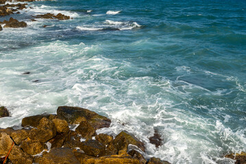Sea waves crashing on rocks.