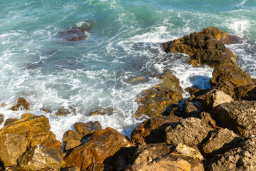 Sea waves crashing on rocks.
