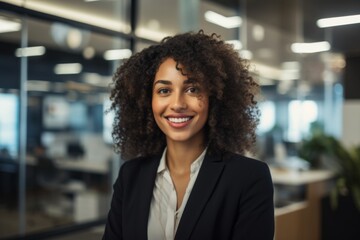 Fototapeta premium Smiling portrait of a young African American businesswoman in modern office