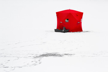 Ice fishing shelter or tent on a frozen lake