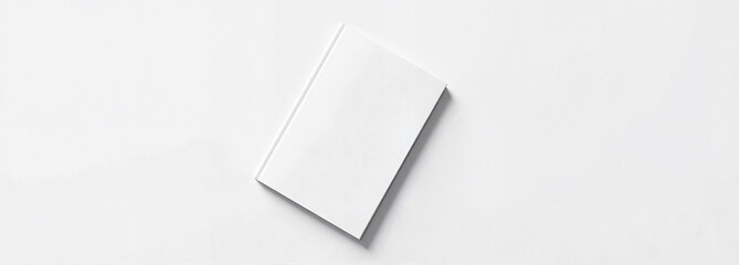 Blank white book on minimalist surface