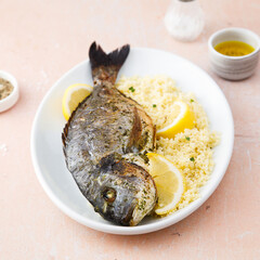 Baked dorado with lemon and couscous