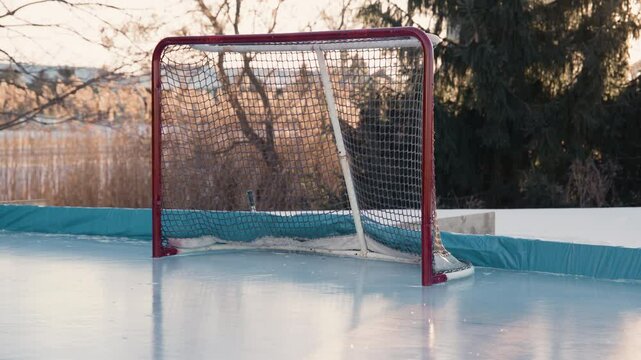 Handheld view of hockey net on outdoor rink