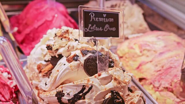  Premium oreo ice cream with chocolate in an Italian ice cream gelato shop. Close up. Pink