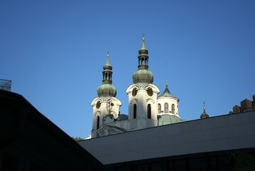 Obraz premium Church towers silhouette. Green domes architecture. Deep blue sky. Historic religious landmark. 