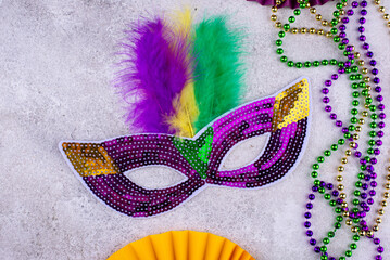 Vibrant Mardi Gras background with mask, beads, and festive decorations