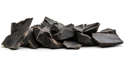 Scattered dark chocolate chunks and shavings on a clean white background, perfect for dessert visuals, baking themes, or confectionery concepts