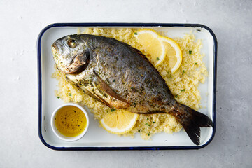 Baked dorado with lemon and couscous