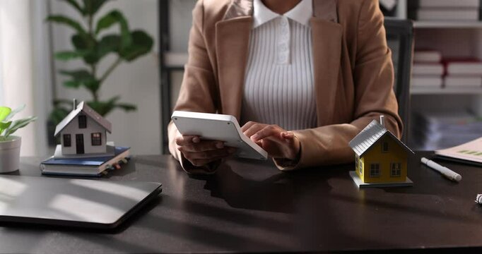 Female woman hands holding home model, small miniature white toy house. Mortgage property insurance dream moving home and real estate concept