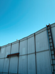 Weathered concrete wall with chipped paint and rusted metal accents, texture, aged, decay, rough