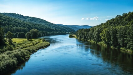Fototapeta premium serene river flowing through lush green valleys under a clear blue sky