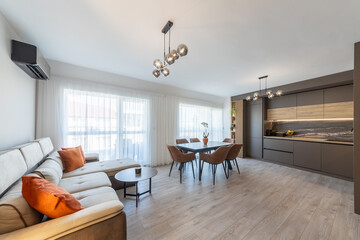 New modern living room with kitchen. New home. Interior photography. Wooden floor