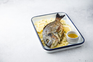 Baked dorado with lemon and couscous