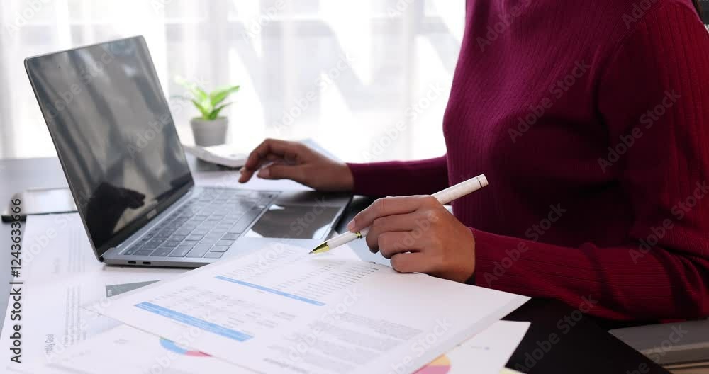 Wall mural Business financing accounting banking concept. Business woman hand doing finances and calculate on desk about cost at home office. Woman working on desk with using calculator, finance accounting.