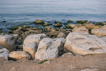 The rocky coast of the Caspian Sea. Cliffs on the seashore. Landscape with a view of the stones on the shore of the Caspian Sea in Dagestan.