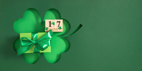 St. Patrick's Day celebration. Wooden cubic calendar with date March 17 and a green gift with a...