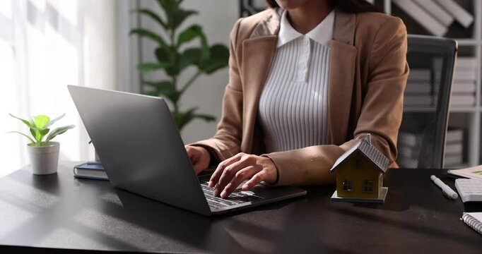 Female woman hands holding home model, small miniature white toy house. Mortgage property insurance dream moving home and real estate concept