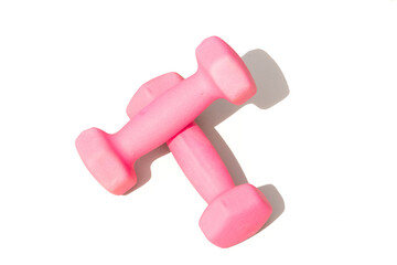 A set of soft pink dumbbells positioned on a white backdrop, ideal for fitness motivation and...
