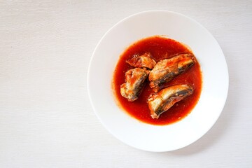 Sardines in tomaro sauce ,canned fish,Tinned fish in a white plate on white background