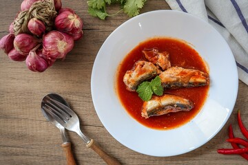 Sardines in tomaro sauce ,canned fish,Tinned fish in a white plate