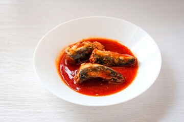 Sardines in tomaro sauce ,canned fish,Tinned fish in a white plate on white background