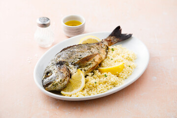 Baked dorado with lemon and couscous