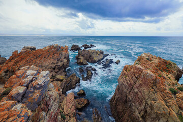 Dramatic South African coast with rocky formations and turbulent waves