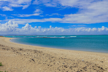 Relaxing beach view in South Africa with turquoise waters and sandy shore under a blue sky