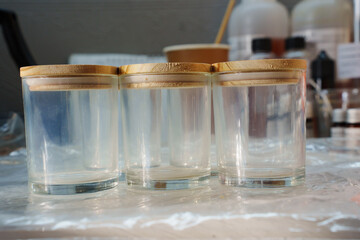 glass glasses with wooden lids for candle making. Hand-made natural candles.