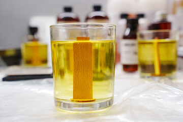 Melted soy wax is poured into a glass glass for a scented candle with a wooden wick. hobby or small...