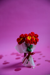 A bouquet of red knitted flowers on a beautiful background, a bouquet of red flowers, knitted flowers, knitted bouquets, handmade, knitted flowers, knitted gifts and toys