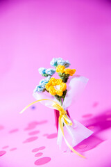 A bouquet of blue and yellow knitted flowers on a beautiful background, knitted flowers, knitted bouquets, handmade, knitted gifts and toys

