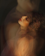 Close romantic art portrait of a girl with flowers in her hair.