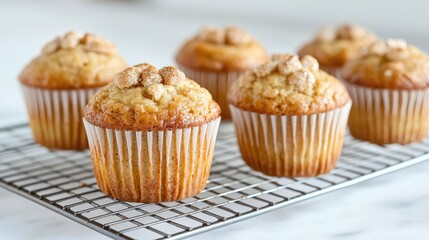 Delicious golden muffins cooling on rack, kitchen setting, food photography
