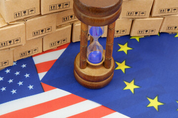 Tariffs and trading ruses changing between EU and USA. European Union and US flags with many carton...