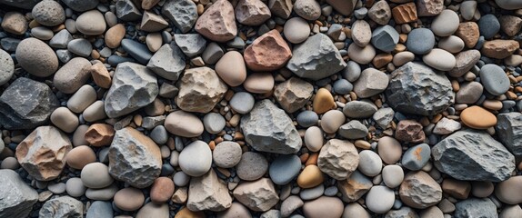 Diverse collection of colorful stones and pebbles showcasing irregular shapes and textures on a rocky surface for natural backgrounds and designs.
