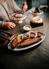 Delicious barbecue platter with sides enjoyed in a cozy restaurant setting during evening hours