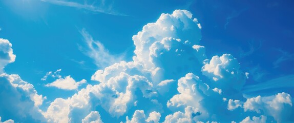 Vibrant blue sky adorned with fluffy white clouds showcasing a serene and peaceful natural landscape ideal for relaxation and inspiration.